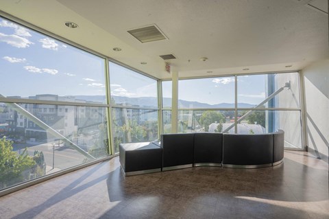 the lobby of a building with large windows and a black couch at The Onyx at 695, Reno, NV, 89503